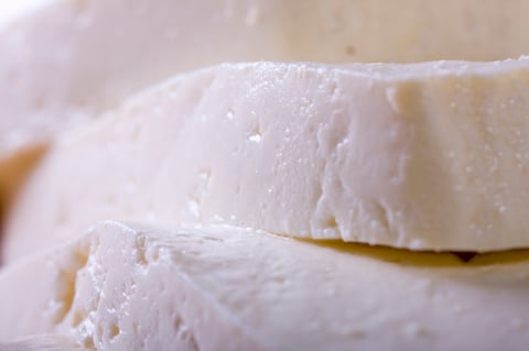 white goat cheese block on wooden board