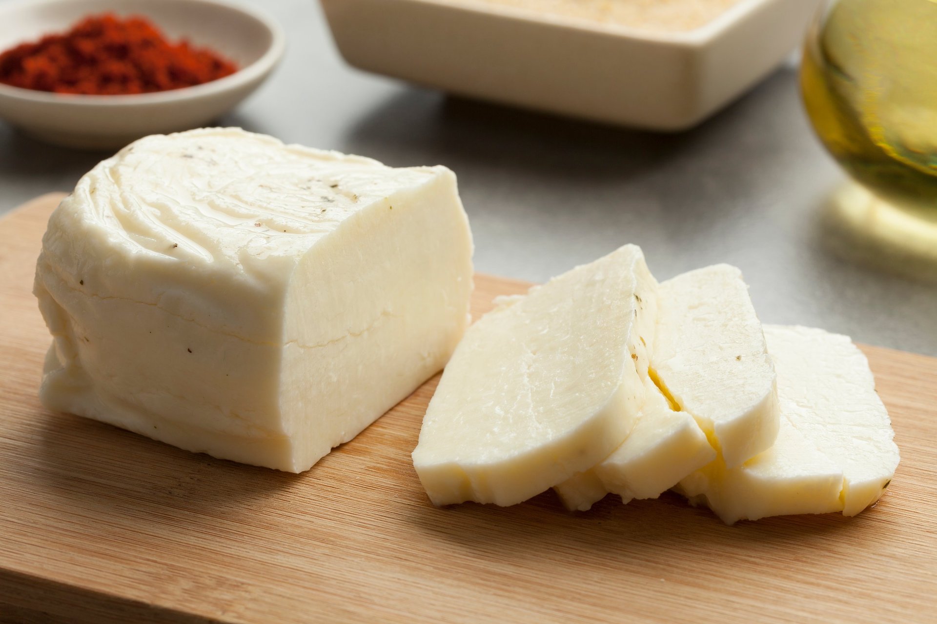 Piece of fresh sliced halloumi on a cutting board