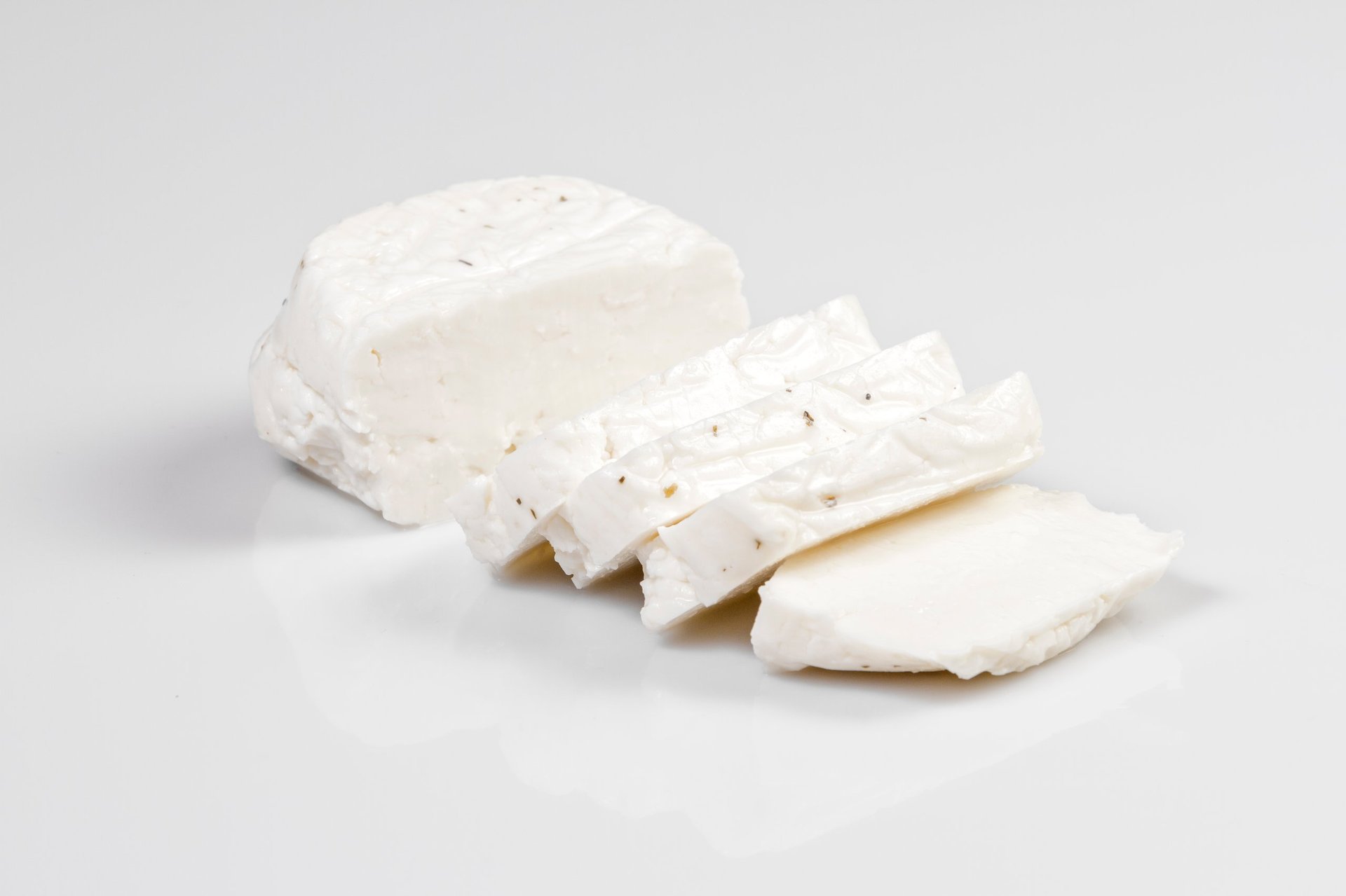 Sliced halloumi cheese with mint isolated on white